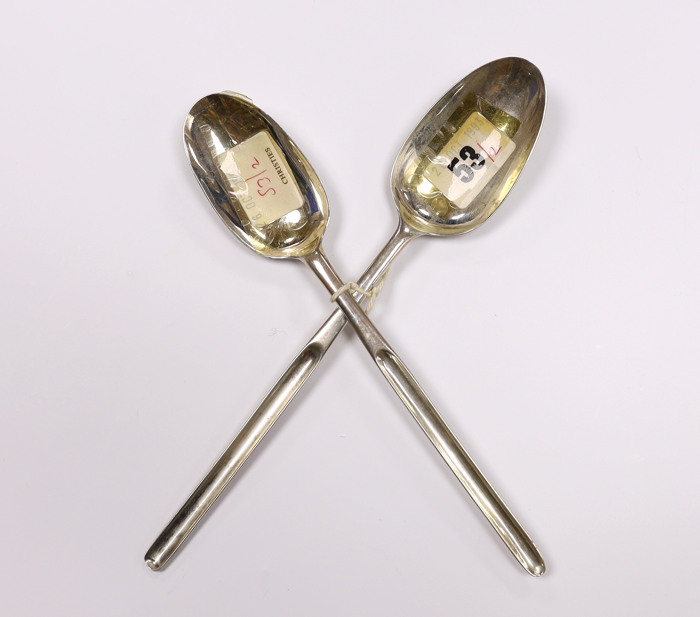 Two 18th century silver combination marrow scoop spoons, London, 1715 and London, 1771, the latter 23.3cm, 91 grams.